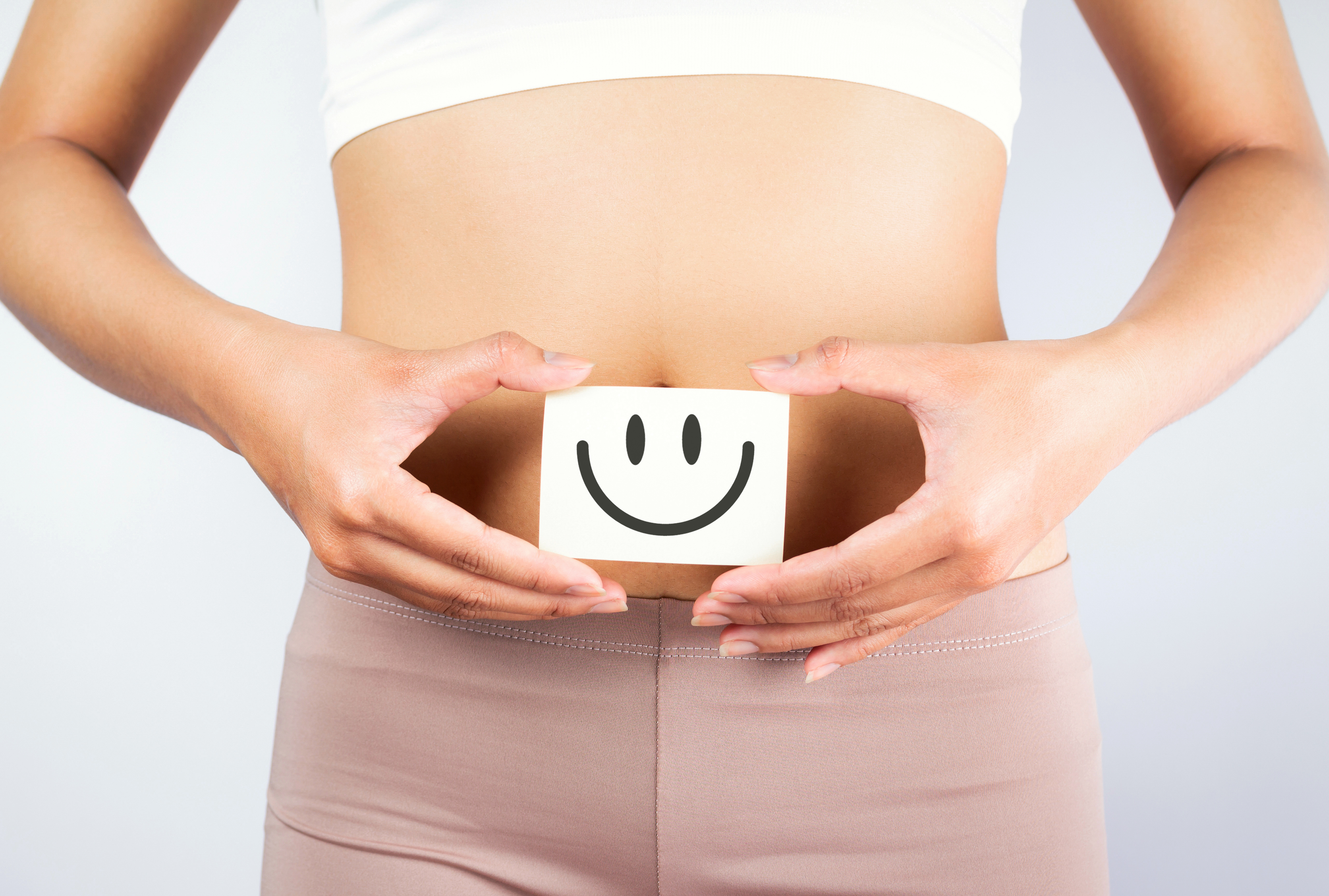 Woman holding a happy gut symbol